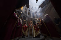 FILE - Orthodox Christian clergy mark Palm Sunday at the Church of the Holy Sepulchre, a place where Christians believe Jesus Christ was crucified, buried and resurrected, in Jerusalem, Sunday, April 17, 2022. During Lent, many Christians observe a 40-day period of penance, prayer and fasting. It is observed from Ash Wednesday through Holy Saturday, the day before Easter, which marks their belief in the resurrection of Jesus from the dead. (AP Photo/Oded Balilty, File)