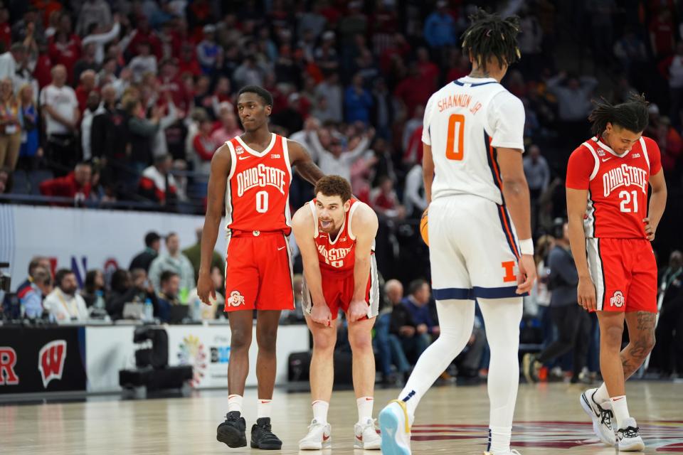 Ohio State guard Scotty Middleton (0) and forward Jamison Battle, center, stand on the court after the team's loss to Illinois in an NCAA college basketball game in the quarterfinals of the Big Ten men's tournament Friday, March 15, 2024, in Minneapolis. (AP Photo/Abbie Parr)