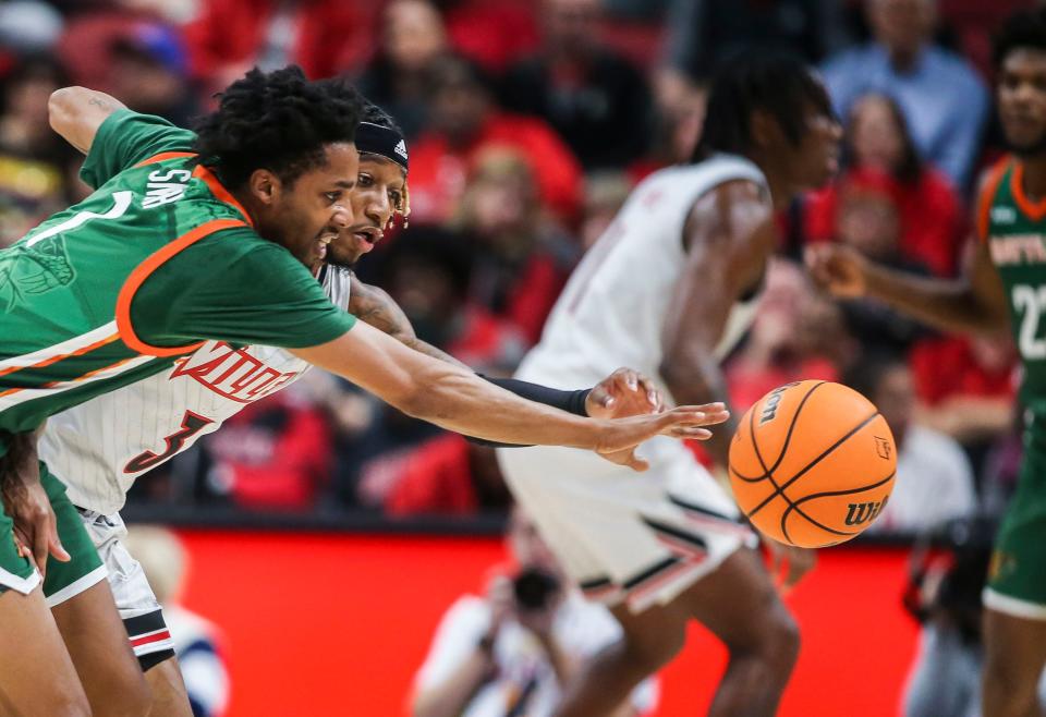 Louisville's El Ellis pressures Florida A&M's Byron Smith in the first half at the YUM! Center in Downtown Louisville Saturday. Dec. 17, 2022 