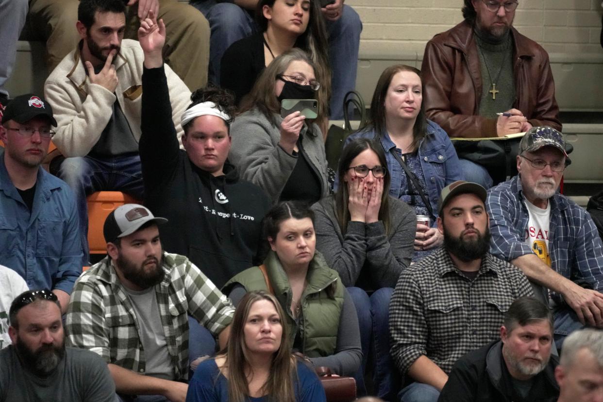 A woman raises her hand with a question during the town hall meeting (Copyright 2023 The Associated Press. All rights reserved)