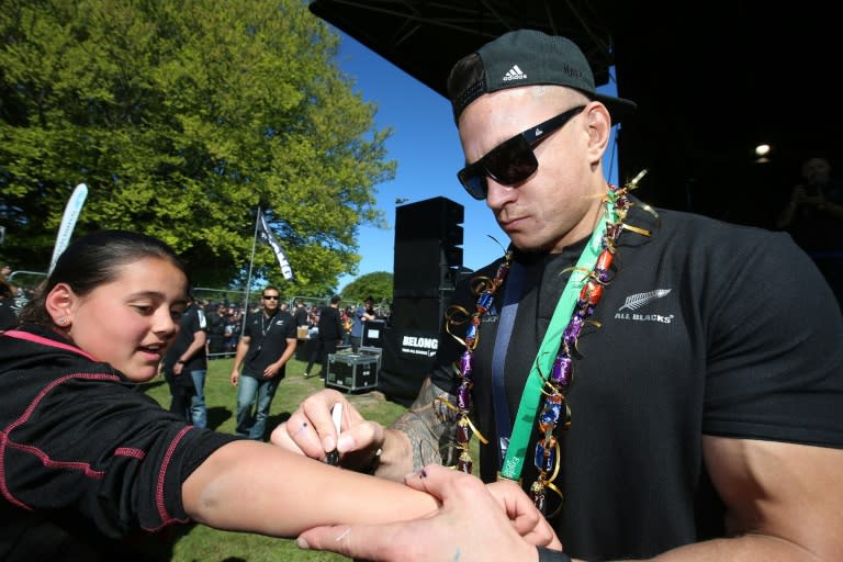 New Zealand's rugby code-hopper Sonny Bill Williams signs his autograph for a fan in Christchurch, in November 2015, following their Rugby World Cup win against Australia in England