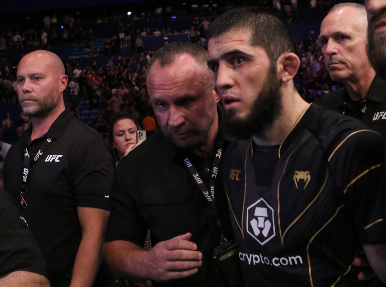 Islam Makhachev (red gloves) celebrates after defeating Alexander Volkanovski (not pictured) for the lightweight championship during UFC 284 at RAC Arena.