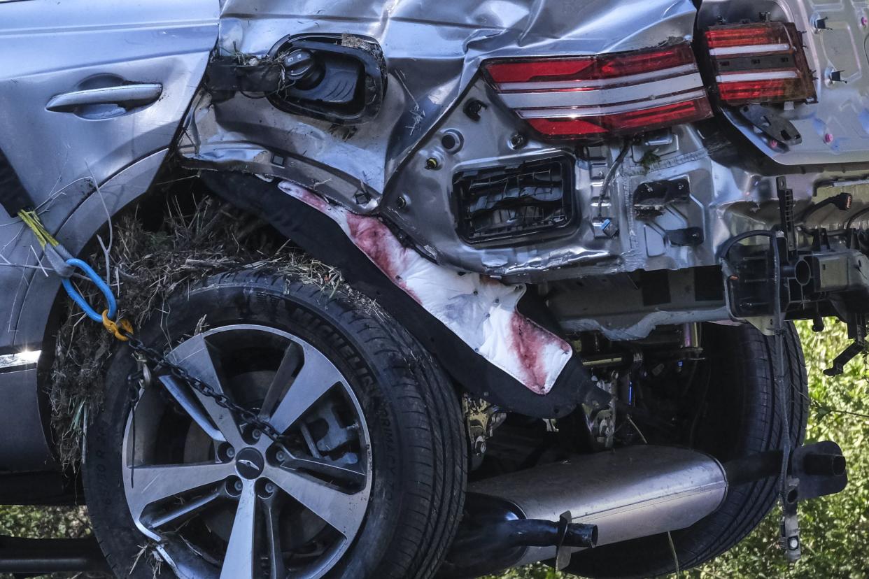 A vehicle rests on its side after a rollover accident involving golfer Tiger Woods along a road in the Rancho Palos Verdes suburb of Los Angeles on Tuesday, Feb. 23, 2021.