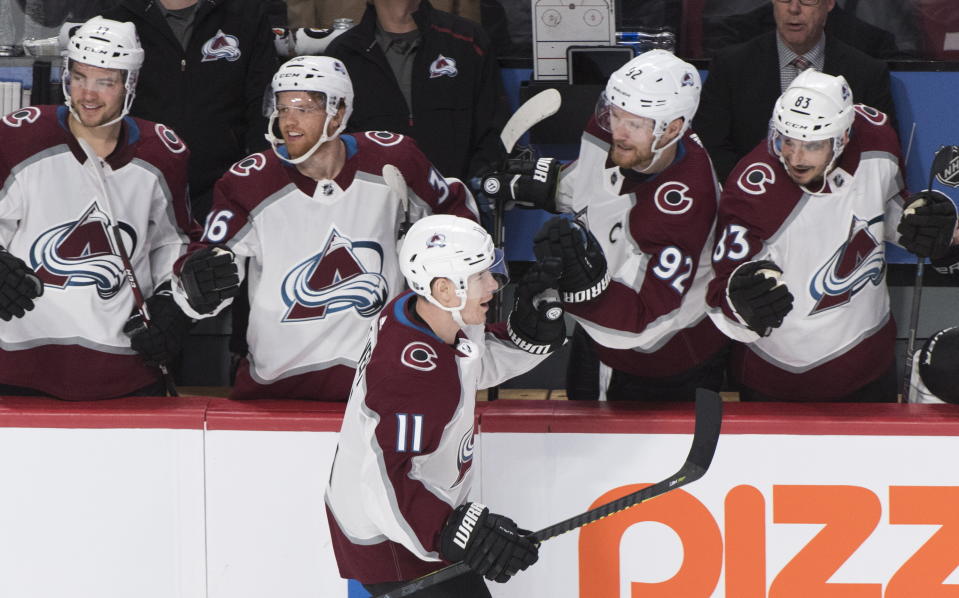 Colorado Avalanche's Matt Calvert (11) celebrates with teammates after scoring against the Montreal Canadiens during the second period of an NHL hockey game Thursday, Dec. 5, 2019, in Montreal. (Graham Hughes/The Canadian Press via AP)