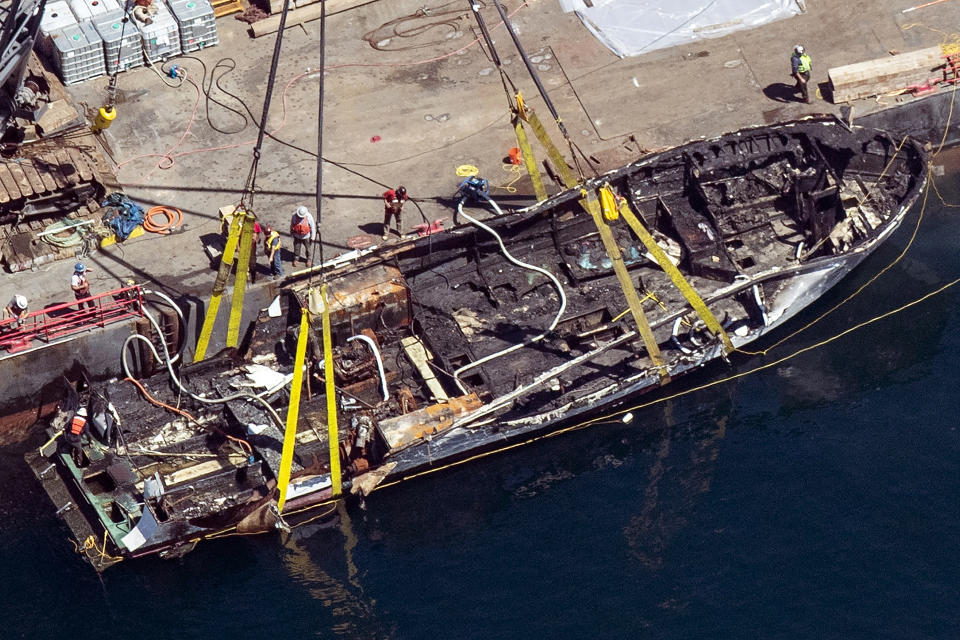 FILE - In this Sept. 12, 2019, file photo, the burned hull of the dive boat Conception is brought to the surface by a salvage team in the Santa Barbara Channel off Santa Cruz Island in Southern California. The families of the 34 people who perished in the boat fire on Sept. 2, 2019, have formed a group they're calling "Advocacy34" to push for strengthened boating regulations and requirements for passenger vessels, such as improved fire and safety training protocols and the installation and use of monitoring devices that would ensure there's a night watch on deck. (Brian van der Brug/Los Angeles Times via AP, File)