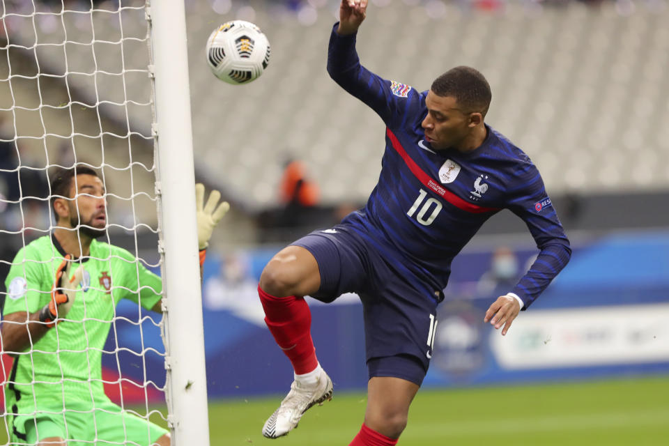 France's Kylian Mbappe challenges Portugal goalkeeper Rui Patricio, left, during the UEFA Nations League soccer match between France and Portugal at the Stade de France in Saint-Denis, north of Paris, France, Sunday, Oct. 11, 2020. (AP Photo/Thibault Camus)