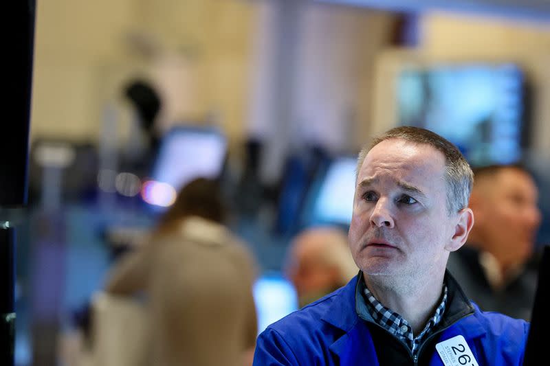 FILE PHOTO: Traders work on the floor of the NYSE in New York