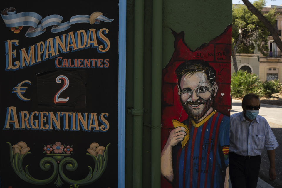 Un mural con la imagen del delantero argentino Lionel Messi frente a un negocio de empanadas en Barcelona, España, el miércoles 26 de agosto de 2020. (AP Foto/Felipe Dana)