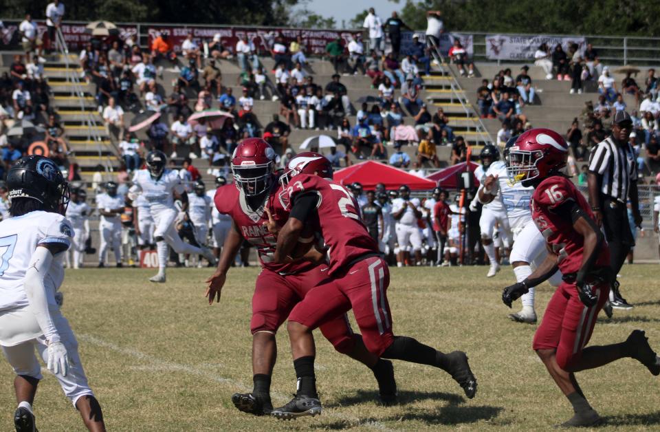 Raines running back Mark Miller (23) follows blockers downfield on his way to a 48-yard touchdown reception during the Northwest Classic.