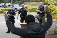 Ken Westphal, center, an officer with the Lacey Police Dept. and an instructor at the Washington state Criminal Justice Training Commission, works with cadets LeAnne Cone, of the Vancouver Police Dept., and Kevin Burton-Crow, right, of the Thurston Co. Sheriff's Dept., during a training exercise Wednesday, July 14, 2021, in Burien, Wash. Washington state is embarking on a massive experiment in police reform and accountability following the racial justice protests that erupted after George Floyd's murder last year, with nearly a dozen new laws that took effect Sunday, July 25, but law enforcement officials remain uncertain about what they require in how officers might respond — or not respond — to certain situations, including active crime scenes and mental health crises. (AP Photo/Ted S. Warren)