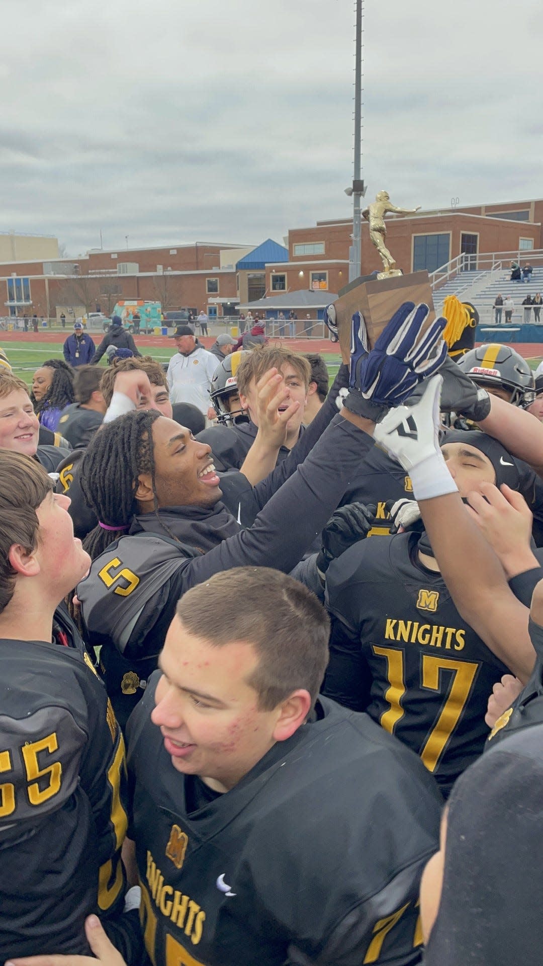 McQuaid senior Shemir Bridges holds the Section V Class AA championship brick after a 45-15 win over UPrep.