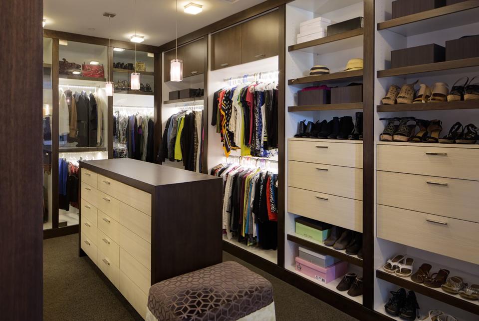 A custom master closet with plenty of wardrobe storage