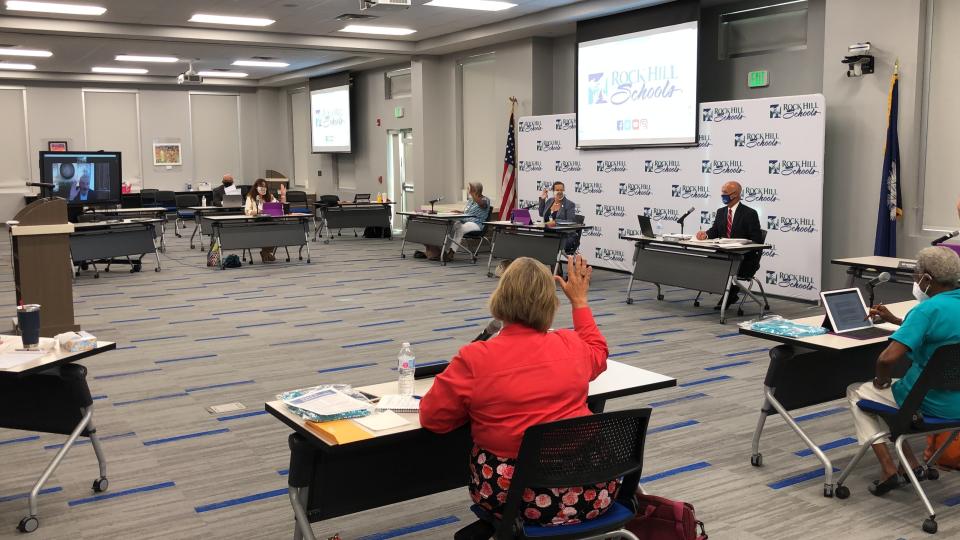 The Rock Hill School Board takes a vote during a meeting in Rock Hill, South Carolina, on Monday, Aug. 10, 2020. Like school boards across the nation, Rock Hill's board has had to answer the simple question when do children return to school with no easy or guaranteed safe answer.(AP Photo / Jeffrey Collins)