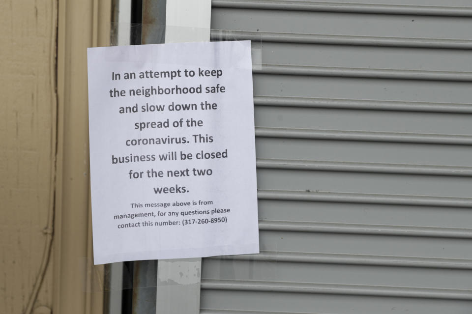 A sign on an Indianapolis liquor store announces its closure due to the coronavirus on March 28, 2020.&nbsp; (Photo: AP Photo/Michael Conroy)