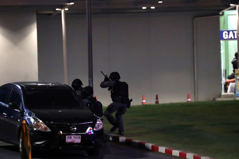 Thailand security forces enter in a shopping mall as they chase a shooter hidden in after a mass shooting in front of the Terminal 21, in Nakhon Ratchasima, Thailand