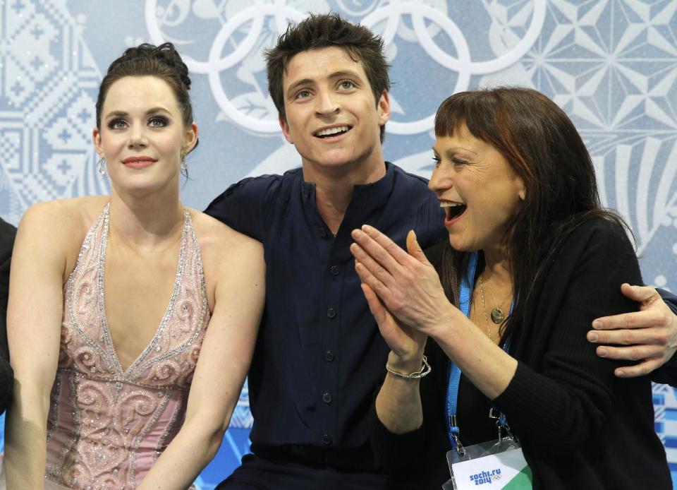 Tessa Virtue and Scott Moir of Canada and their coach Marina Zueva, right, wait in the results area after competing in the ice dance free dance figure skating finals at the Iceberg Skating Palace during the 2014 Winter Olympics, Monday, Feb. 17, 2014, in Sochi, Russia. (AP Photo/Vadim Ghirda)