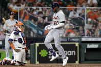 Detroit Tigers' Akil Baddoo (60) reacts as he crosses home plate in front of Houston Astros catcher Martin Maldonado, left, on his home run during the third inning of a baseball game Monday, April 12, 2021, in Houston. (AP Photo/Michael Wyke)