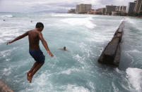 <p>A local resident dives into the water at Waikiki beach on Oahu island on Aug. 24, 2018 in Honolulu, Hawaii. (Photo: Mario Tama/Getty Images) </p>