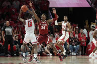 Houston guard Tramon Mark (12) is defended by Alabama forward Brandon Miller (24) during the first half of an NCAA college basketball game, Saturday, Dec. 10, 2022, in Houston. (AP Photo/Kevin M. Cox)