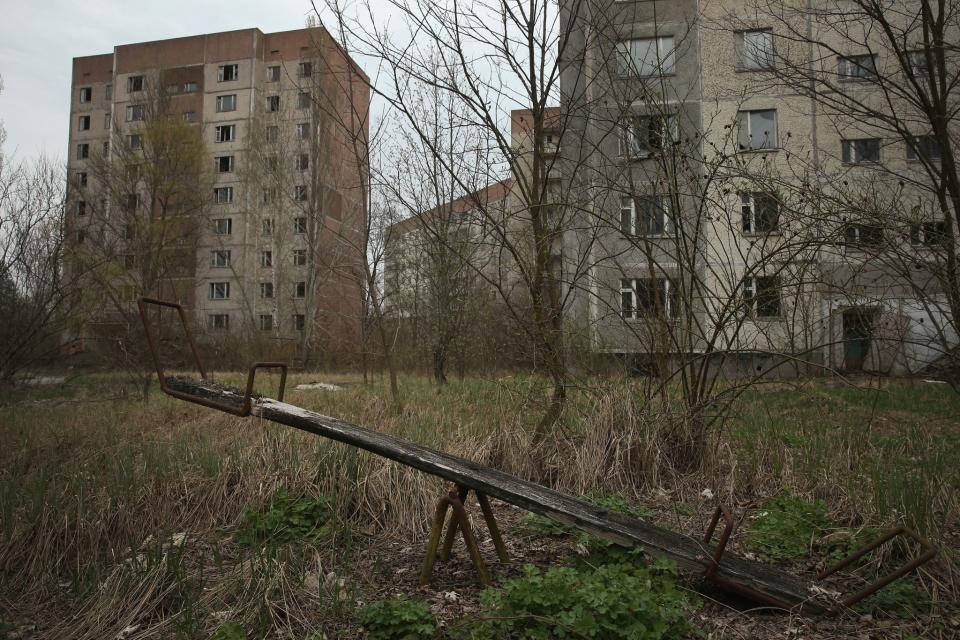 <p>A children’s seesaw stands among former apartment buildings on (Getty Images) </p>