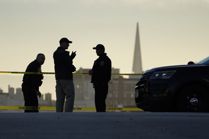 Police stand at the top of the closed street outside the home of Paul Pelosi, the husband of House Speaker Nancy Pelosi, in San Francisco, Friday, Oct. 28, 2022. Paul Pelosi, was attacked and severely beaten by an assailant with a hammer who broke into their San Francisco home early Friday, according to people familiar with the investigation. In the background is the Transamerica Pyramid.(AP Photo/Eric Risberg)