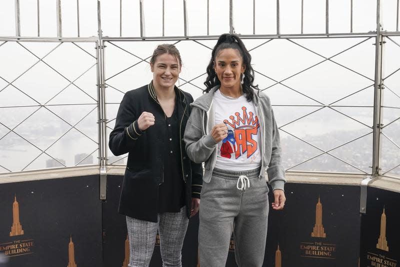 Boxers Amanda Serrano, right, and Katie Taylor pose for pictures on the observation deck of the Empire State Building in New York, Tuesday, April 26, 2022.