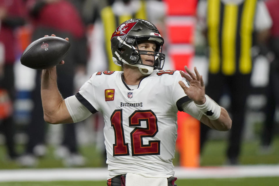 Tampa Bay Buccaneers quarterback Tom Brady (12) works against the New Orleans Saints during the first half of an NFL divisional round playoff football game, Sunday, Jan. 17, 2021, in New Orleans. (AP Photo/Brynn Anderson)