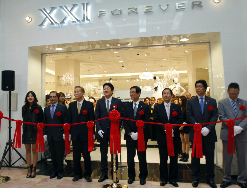 FILE-In this Thursday, April 29, 2010, file photo, Jin Sook Chang, left, attends the opening of a Forever 21 store in Tokyo. Sook and husband Do Won created the Forever 21 clothing chain, which now spans nearly 500 stores. The couple is No. 79 on this year’s Forbes 400 list of richest Americans. Women have helped build some of the biggest companies in America, and they have the bank accounts to show for it. (AP Photo/Shuji Kajiyama, File)