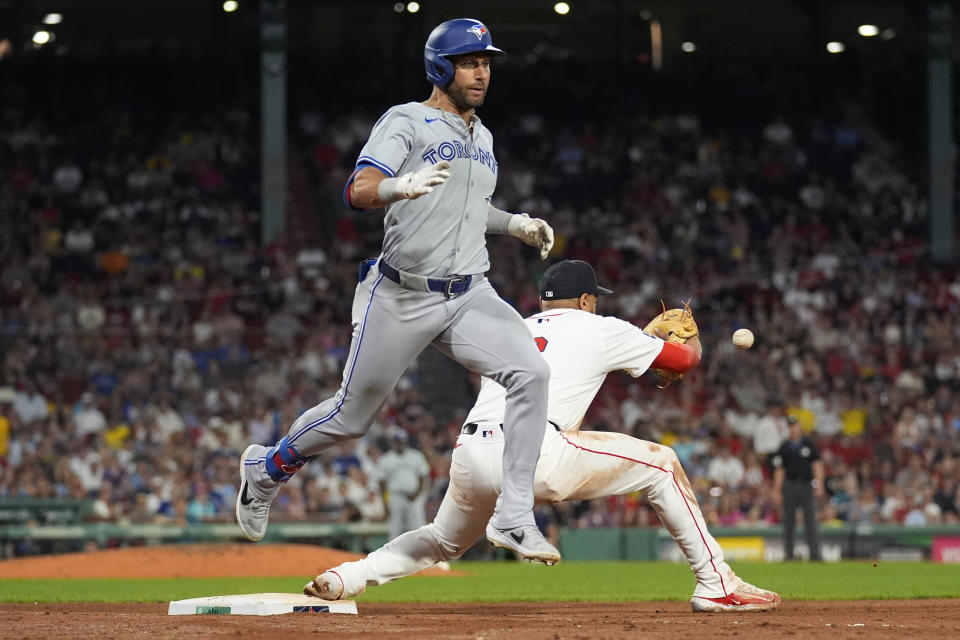 Toronto Blue Jays' Kevin Kiermaier legs out a single as Boston Red Sox first base Dominic Smith waits for the throw during the eighth inning of a baseball game at Fenway Park, Tuesday, June 25, 2024, in Boston. (AP Photo/Charles Krupa)