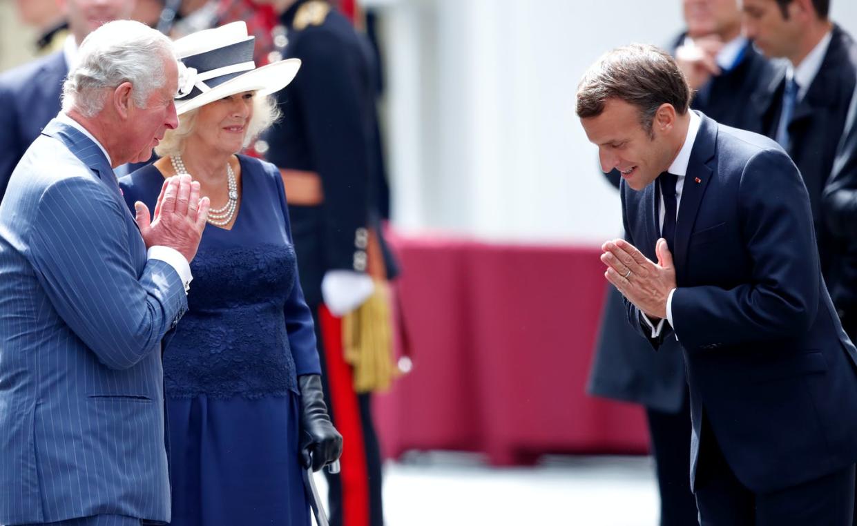 <span class="caption">Prince Charles, accompanied by Camilla, Duchess of Cornwall, and French president Emmanuel Macron greet one another with a 'namaste' in London on June 18.</span> <span class="attribution"><a class="link " href="https://www.gettyimages.com/detail/news-photo/prince-charles-prince-of-wales-accompanied-by-camilla-news-photo/1250550316?adppopup=true" rel="nofollow noopener" target="_blank" data-ylk="slk:Photo by Max Mumby/Indigo/Getty Images;elm:context_link;itc:0;sec:content-canvas">Photo by Max Mumby/Indigo/Getty Images</a></span>