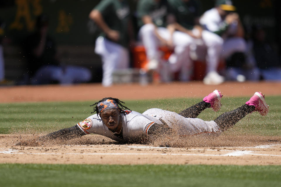 Baltimore Orioles' Jorge Mateo slides home to score on his inside-the-park home run during the second inning of a baseball game against the Oakland Athletics in Oakland, Calif., Sunday, Aug. 20, 2023. (AP Photo/Jeff Chiu)
