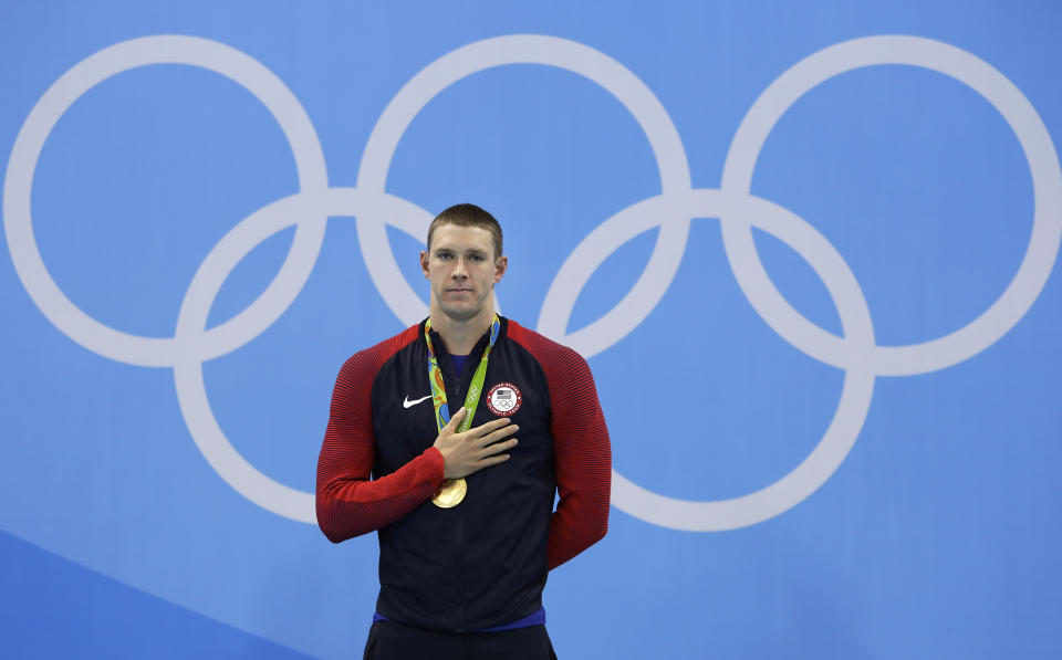 FILE - United States' gold medal winner Ryan Murphy listens to the anthem during the medal ceremony for the men's 200-meter backstroke final during the swimming competitions at the 2016 Summer Olympics in Rio de Janeiro, Brazil, in this Thursday, Aug. 11, 2016, file photo. The last time the American men lost a backstroke race at the Olympics, Ryan Murphy wasn't even born. It's likely up to him to keep the remarkable streak alive. (AP Photo/Michael Sohn, File)