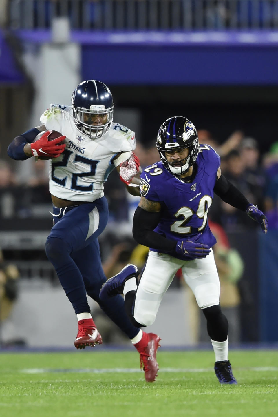 Tennessee Titans running back Derrick Henry (22) runs against Baltimore Ravens free safety Earl Thomas (29) during the first half an NFL divisional playoff football game, Saturday, Jan. 11, 2020, in Baltimore. (AP Photo/Gail Burton)