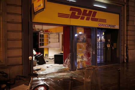 A vandalized shop is seen on a street the morning after clashes between police and protesters wearing yellow vests, a symbol of a French drivers' protest against higher diesel taxes, in Paris, France, December 2, 2018. REUTERS/Benoit Tessier