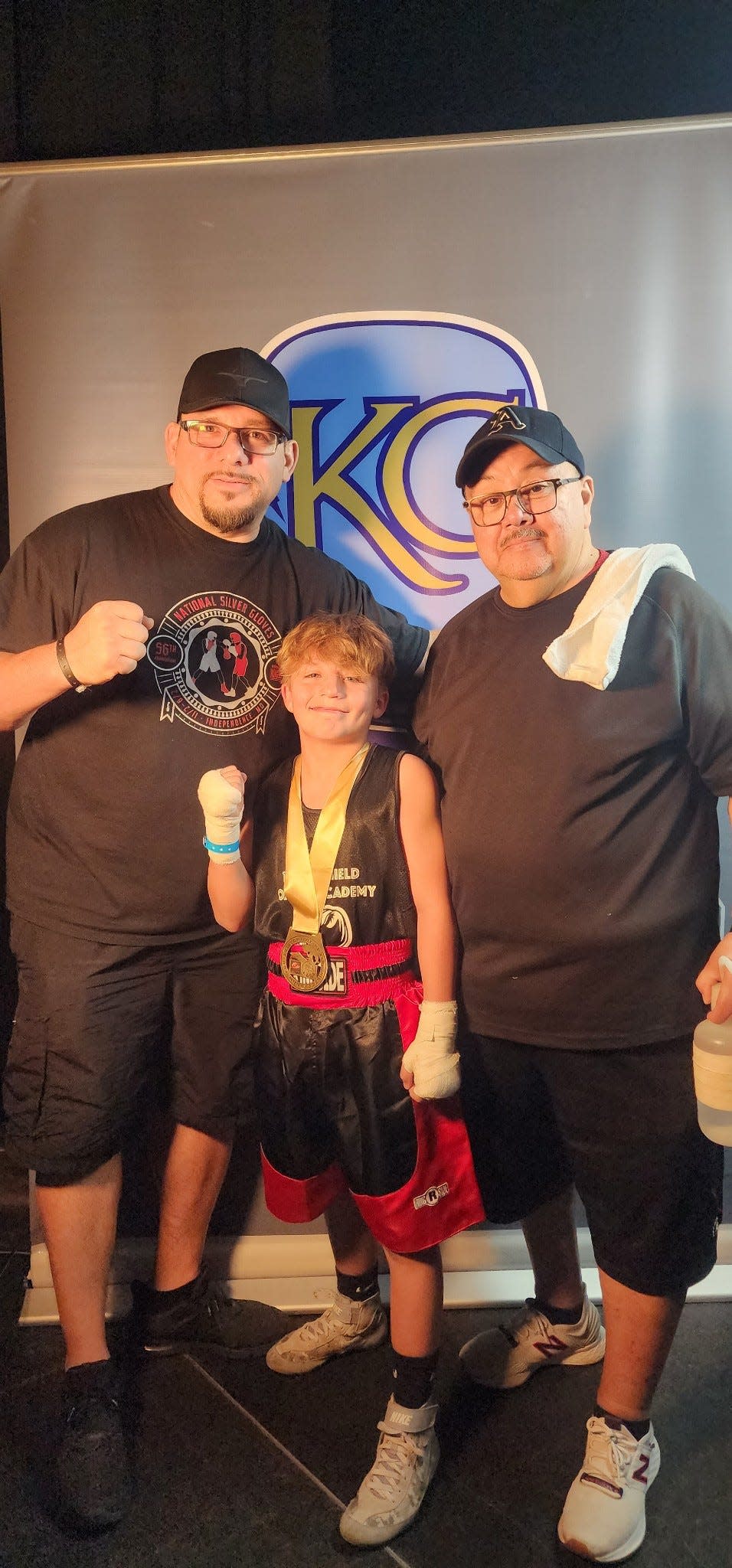 James Garcia, left, and his son Peyton Sewell, 12, talk with John Alcala at the Golden Gloves regional championships over the weekend.