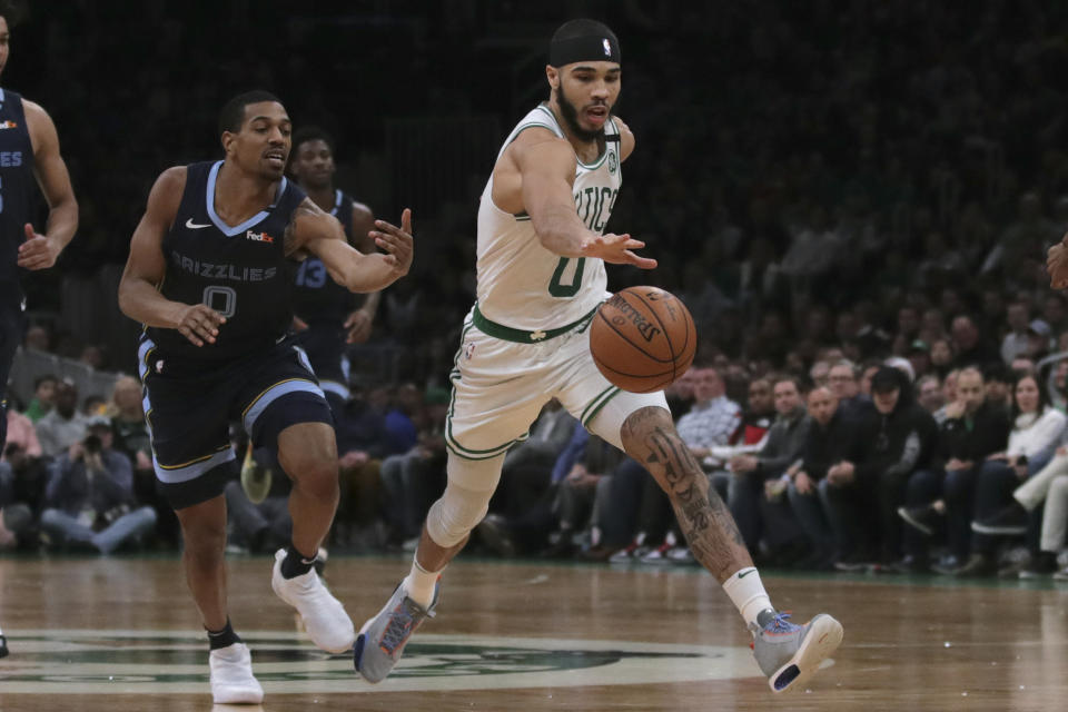 Boston Celtics forward Jayson Tatum, right, chases a loose ball against Memphis Grizzlies guard De'Anthony Melton, left, during the second half of an NBA basketball game in Boston, Wednesday, Jan. 22, 2020. (AP Photo/Charles Krupa)