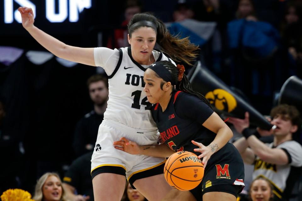 Maryland guard Brinae Alexander, right, goes to the basket as Iowa guard McKenna Warnock defends her in the first half of an NCAA college basketball game at the Big Ten women's tournament Saturday, March 4, 2023, in Minneapolis. (AP Photo/Bruce Kluckhohn)