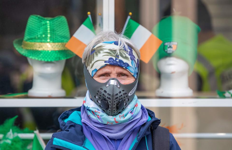 Breda Brody, a former Nurse, poses for a picture wearing a filter mask in the Grafton shopping area of in Dublin on March 12, 2020. - Ireland on Thursday announced the closure of all schools and colleges, and recommended the cancellation of mass gatherings as part of measures to combat the spread of the coronavirus. Prime Minister Leo Varadkar said "schools, colleges and childcare facilities will close from tomorrow (Friday)", as would state-run cultural institutions. (Photo by Paul Faith / AFP) (Photo by PAUL FAITH/AFP via Getty Images)