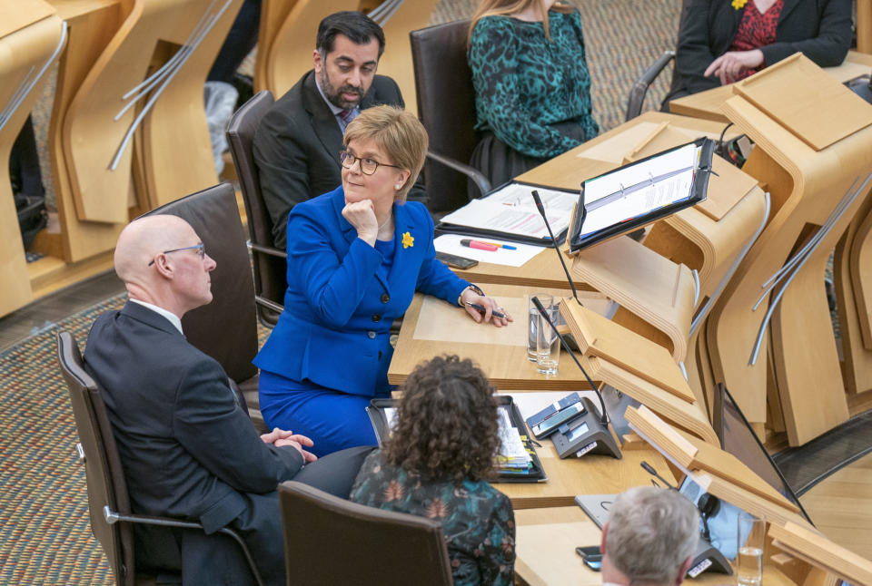 Outgoing Scottish First Minister Nicola Sturgeon in the main chamber after her last First Minister's Questions (FMQs) in the main chamber of the Scottish Parliament in Edinburgh, Thursday March 23, 2023. (Jane Barlow/PA via AP)