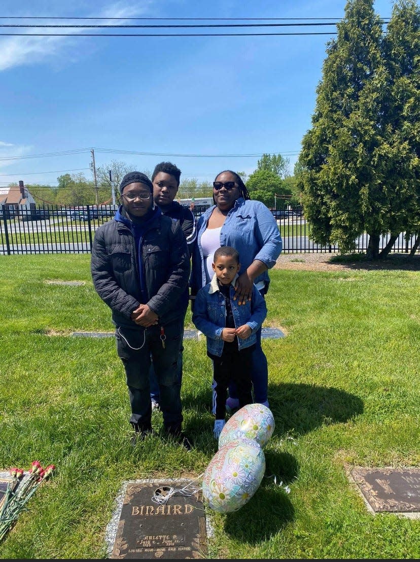 Shantasia Binaird with her three sons: 16-year-old Jarmar (left),  Jai’Mire, 20, (center) and Jasire, 7. The four were visiting her mother's gravesite last year. Shantasia Binaird is now buried with her mother.