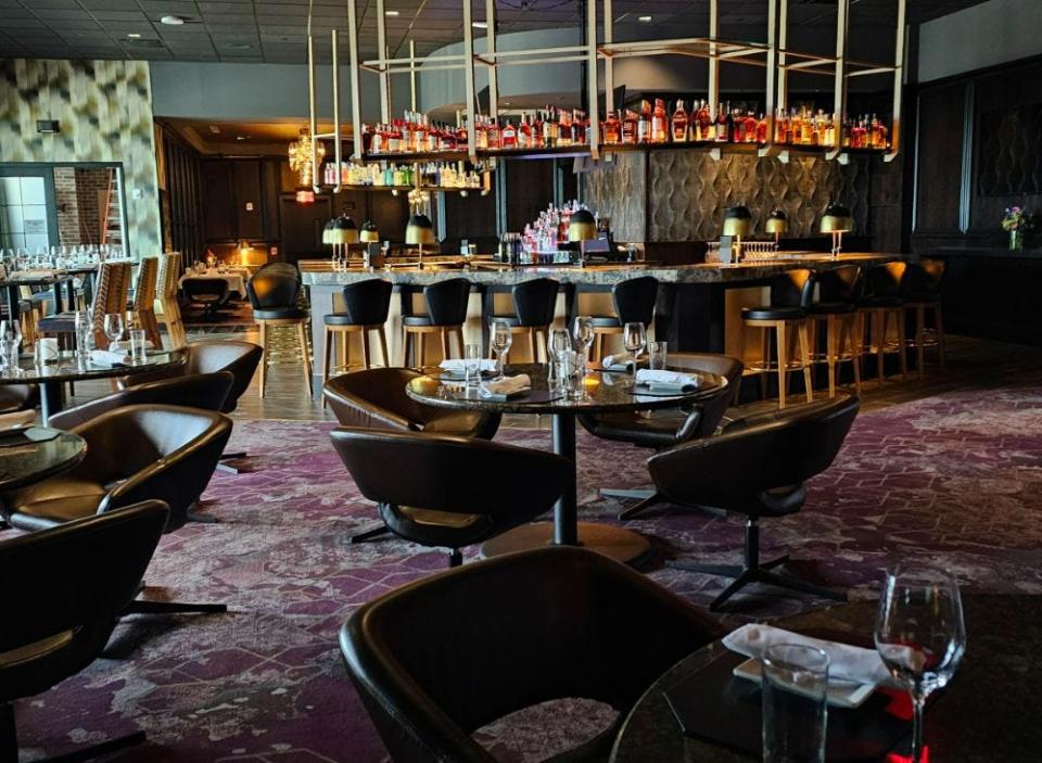 The second-floor bar features backlit bottles overhead and 25 seats at Ruth's Chris Steak House in West Des Moines.