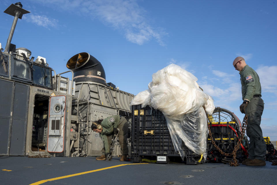 FILE - In this image released by the U.S. Navy, sailors assigned to Assault Craft Unit 4 prepare material recovered off the coast of Myrtle Beach, S.C., in the Atlantic Ocean from the shooting down of a Chinese high-altitude balloon, for transport to the FBI, at Joint Expeditionary Base Little Creek in Virginia Beach, Va., on Feb. 10, 2023. U.S. officials say the military has finished efforts to recover the remnants of the large balloon, and analysis of the debris so far reinforces conclusions that it was a Chinese spy balloon. (Ryan Seelbach/U.S. Navy via AP, File)