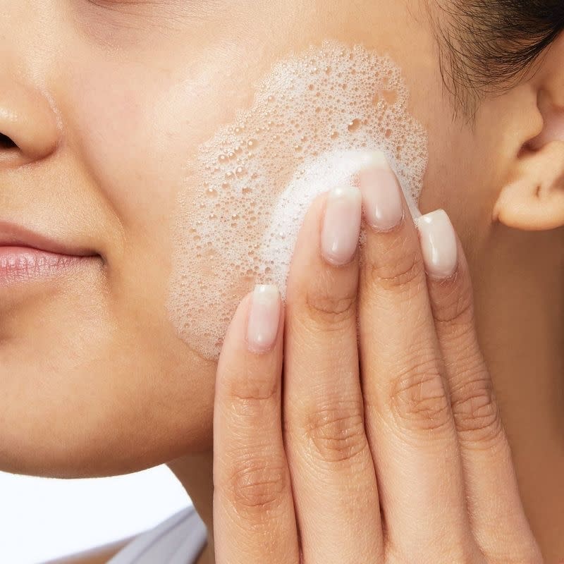 a model using the foamy wash on their face