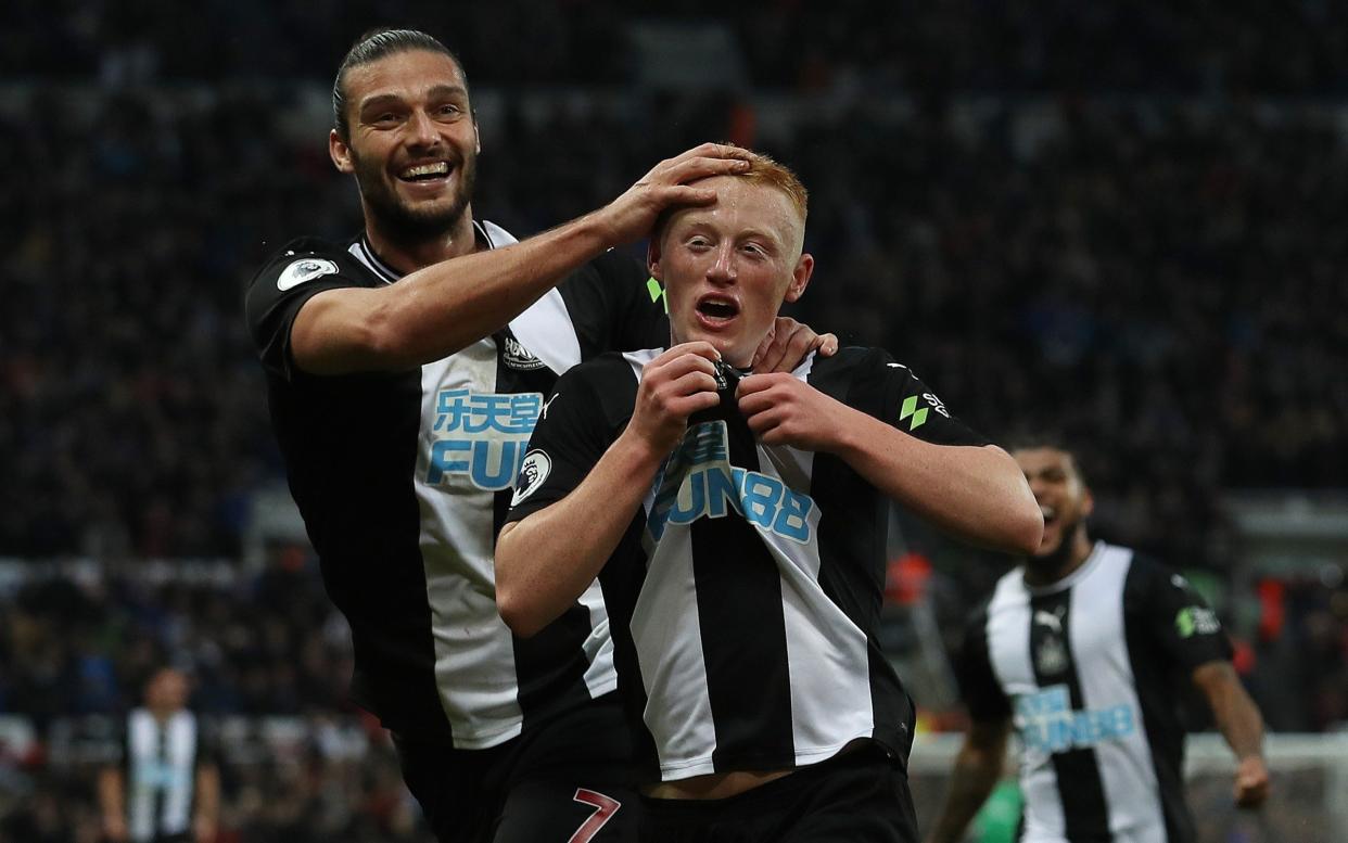 Matty Longstaff of Newcastle United celebrates with team mate Andy Carroll after he scores the only goal of the game during the Premier League match between Newcastle United and Manchester United at St. James Park - Getty Images