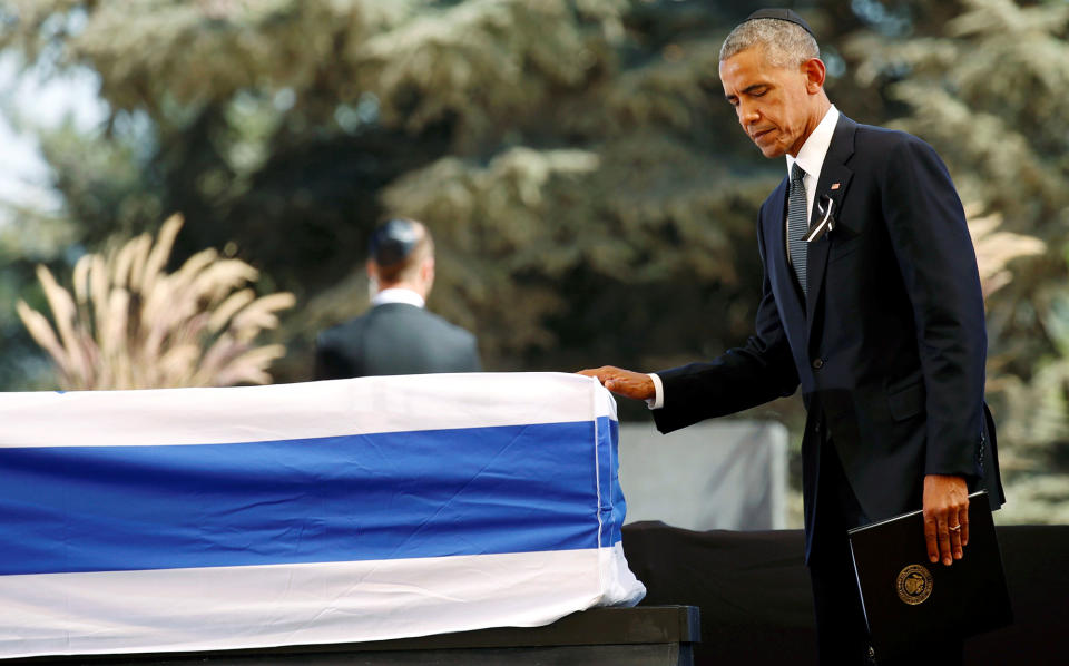 <p>President Barack Obama touches the flag-draped coffin of former Israeli President Shimon Peres, after eulogising him at his funeral ceremony in Mount Herzl cemetery in Jerusalem September 30, 2016. (Kevin Lamarque/Reuters) </p>