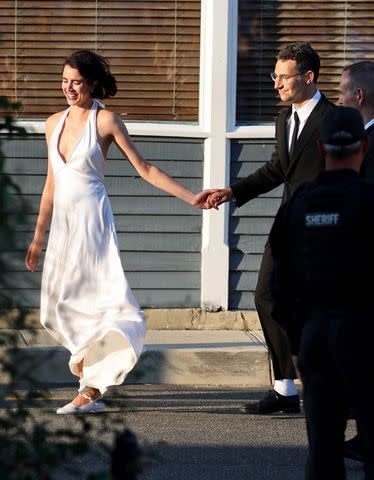 <p>T.JACKSON / BACKGRID</p> Margaret Qualley and Jack Antonoff hold hands at their wedding.