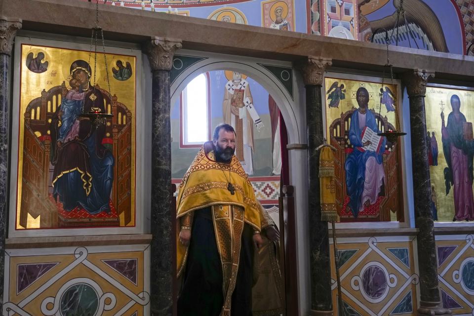 Russian Orthodox Priest the Rev. Andrei Kordochkin conducts a religion service at the Russian Cathedral of Saint Mary Magdalene in Madrid, Spain, Saturday, July 15, 2023. In February, Moscow's Patriarch Kirill suspended Kordochkin, a priest at an Orthodox church in Madrid, after he condemned the Kremlin's decision to send troops to Ukraine. Church officials said Kordochkin was punished for "inciting hatred" among his parishioners, but the priest argues it's a warning to dissuade him from further criticism. (AP Photo/Paul White)