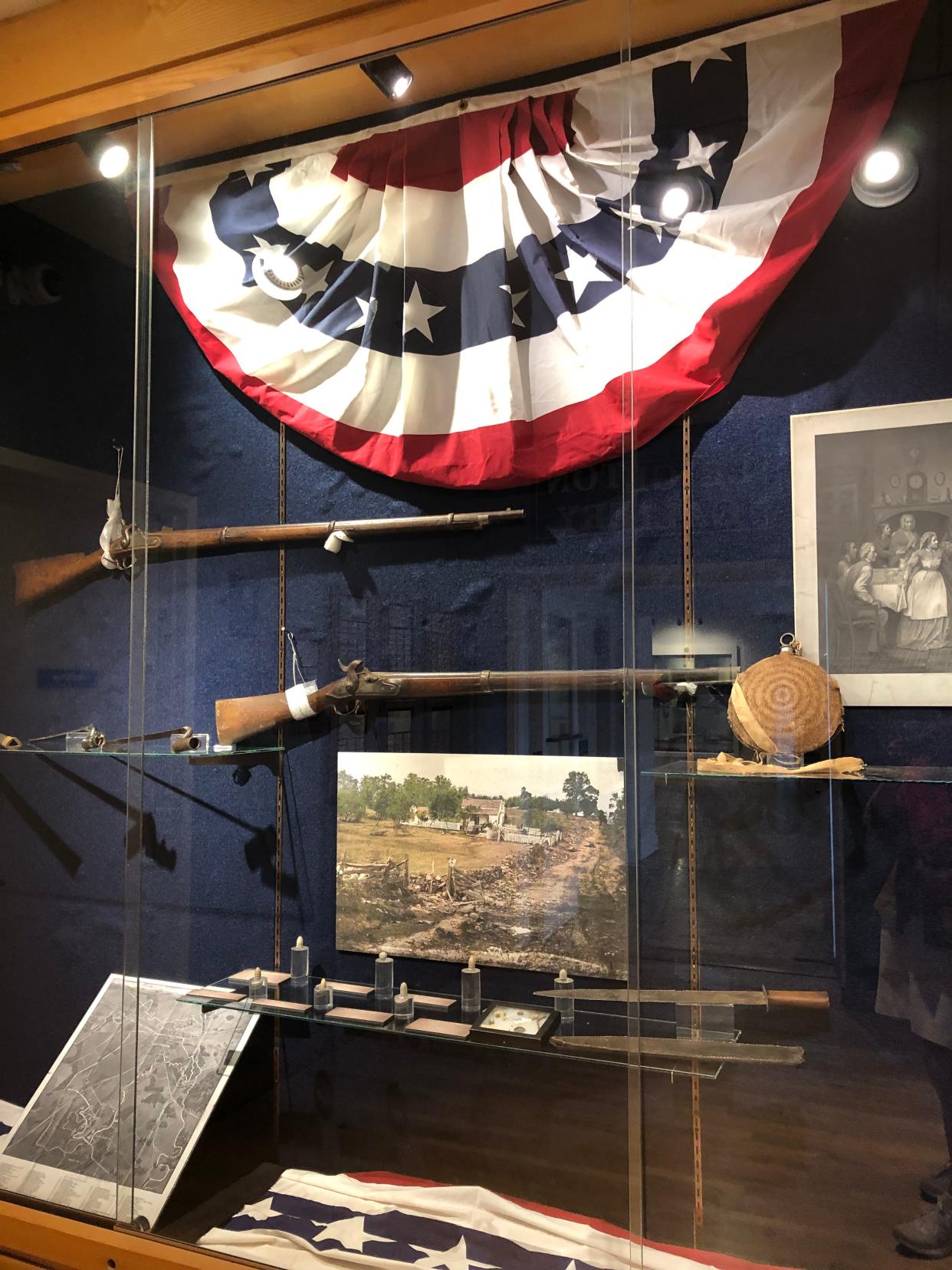 Photos and artifacts included in this case as part of the exhibit "Turning Point: The Battle of Gettysburg, 1863" are a colorized photograph of the aftermath of the Gettysburg three-day battle; an 1864 Springfield rife, standard equipment in the Union Army; and an 1860s battlefield map of Gettysburg. The exhibit will be open from July 1, 2023, to July 7, 2024, at The History Museum in South Bend.