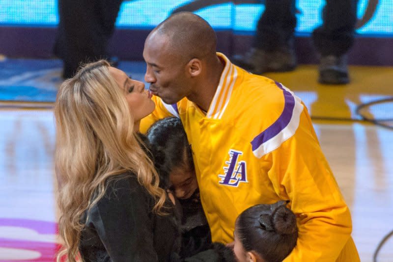 Kobe Bryant (R) shares a moment with Vanessa Bryant and two of their daughters prior to a Los Angeles Lakers and Oklahoma City Thunder basketball game in 2014. File Photo by Jon SooHoo/UPI