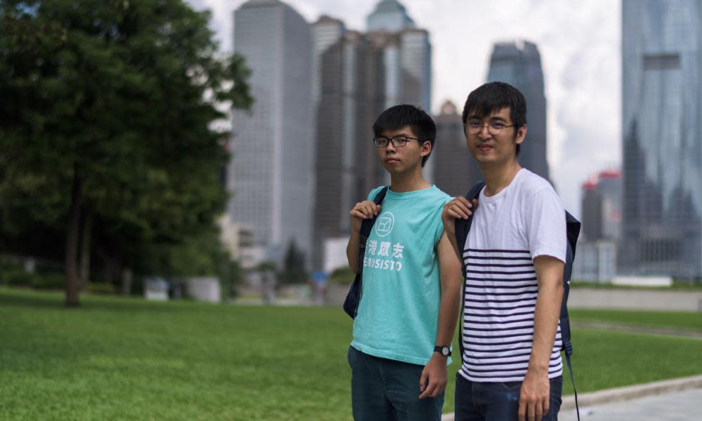 Joshua Wong (L) and Alex Chow, leaders of Hong Kong’s ‘Umbrella Movement’, before their court appearance